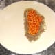 Baked beans are spooned on top of the beef.