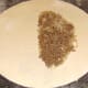 Cooled beef and onion is added to pastry.