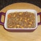 Beef and bean combination is added to baking dish.