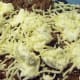 Top with veggie crumbles, ricotta cheese, and shredded mozzarella.