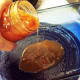 Spread a thin layer of diced tomatoes onto bottom of greased pan.