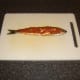 Red pesto sauce is spread on the herring