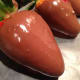 Dip the strawberry in the chocolate