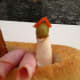 7. Roll another deli meat slice and cut in half. Make a pirate with each half by adding a green olive for the head and the pimiento as the hat.