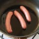 The sausages have to go in to the pan first.