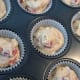 Muffin batter spooned into cases.