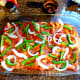 Sprinkle half of the green peppers and onions on top of mixture.