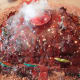 The lava is running down the sides of this smoking volcano cake.
