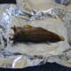 Arbroath smokie is laid on lightly buttered foil