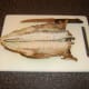 A sharp knife is used to help open and flatten the Arbroath smokie