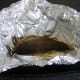 Reheated Arbroath smokie is carefully unwrapped