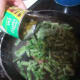 Add entire contents of one can of green beans to frozen ones.
