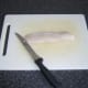 Fillet is laid on a chopping board, skin side down