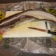 A lateral cut is made along the length of the ling to one side of the backbone
