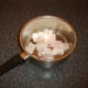 Chopped ling is added to pot for poaching
