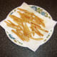 Fries are drained on kitchen paper