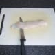 Starting to remove the skin from the fish fillet