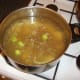 Beef stock is poured in to the vegetable mix