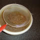 Beef stock is strained