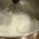 Gradually add in sugar and lemon juice.