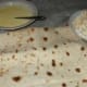 Greased baking pan with lavash on it.
