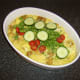 Cucumber, tomatoes and coriander/cilantro are added to the casserole