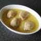 Chicken thighs are laid skin sides up on top of rice and stock