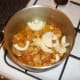 Onion and galric is added to the browned chicken thighs
