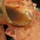 Marinade is poured over seasoned chops to create amazing flavor.