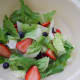 Rinse and drain greens and berries.