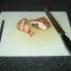 At an angle, halve rested stuffed chicken breast