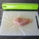 Lay chicken breast fillet on cling film