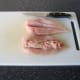 Place pork stuffing inside the first chicken fillet (the second fillet is carved and ready)