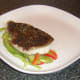 Pollack fillet is laid on bell pepper bed