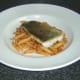 Pollack fillet is lifted on to penne pasta bed