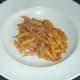 Penne pasta is plated as a bed for pollack fillet