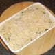 Cheese and breadcrumbs are scattered over potatoes and broccoli