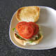 Tomato slices top steak