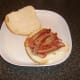 Crispy bacon is laid on steak