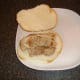 Pork leg steak is laid on bread roll