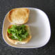 Rocket/arugula is added to bottom of roll