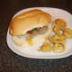 Burger style pork leg and salsa steak sandwich with onion rings