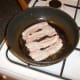 Bacon is fried in steak juices