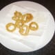Onion rings are drained on kitchen paper