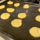 Dip a fork in cold water and pat cookie balls.