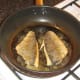 Sea bream fillets are carefully turned on to flesh sides