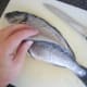 Removing the first fillet from the sea bream