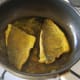 Sea bream fillets complete frying on flesh sides