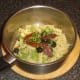 Sun dried tomatoes, olives and parsley are added to fusilli pasta