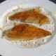 Skin sides or sea bream fillets are patted in seasoned flour